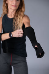Woman with long hair shown in the background wearing Seraphina Safety apparel 18" long flame-resistant, heat-resistant protective sleeves with thumb hole. 