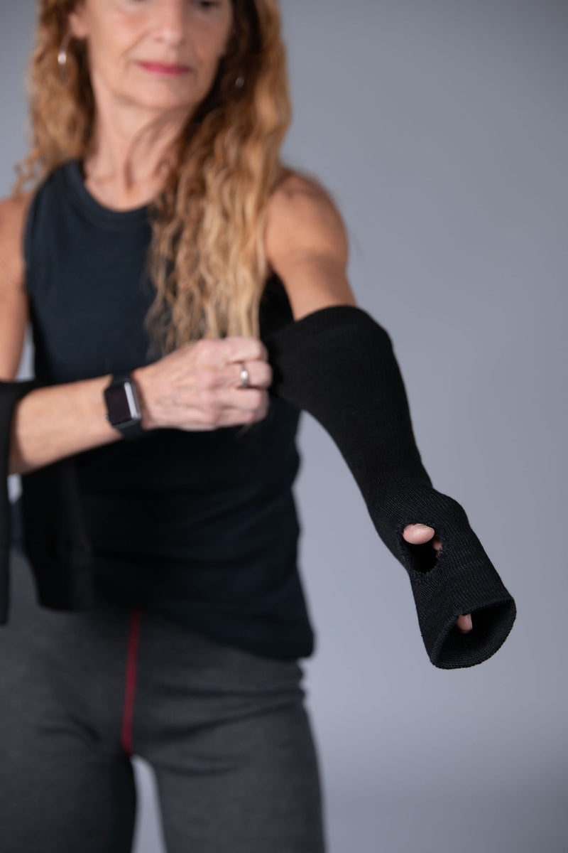 Woman with long hair shown in the background wearing Seraphina Safety apparel 18" long flame-resistant, heat-resistant protective sleeves with thumb hole. 