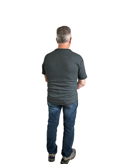 Back view of Man wearing Seraphina flame-resistant short sleeve shirt. Man is wearing jeans and safety shoes. 
